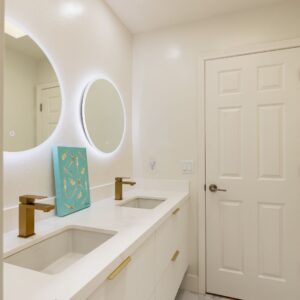 A double vanity with double circular mirrors