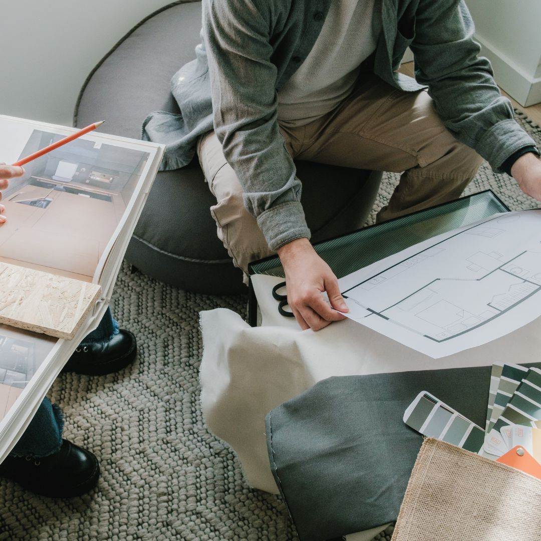 interior designers going over a floor plan and samples